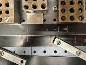 Close-up of metal components and tools on a workbench