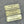 Three brass labels proudly donated by Elora Home Hardware on a gray background