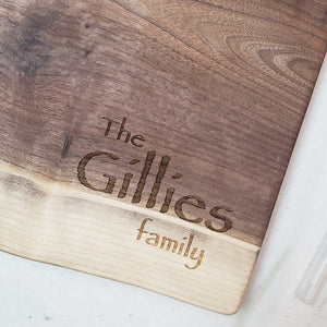 Wooden cutting board with 'The Gilles family' engraving on a white surface