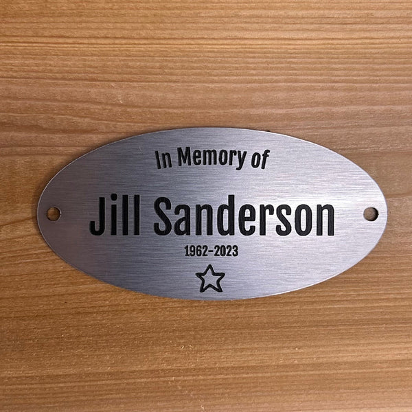 Memorial plaque for  on a wooden background